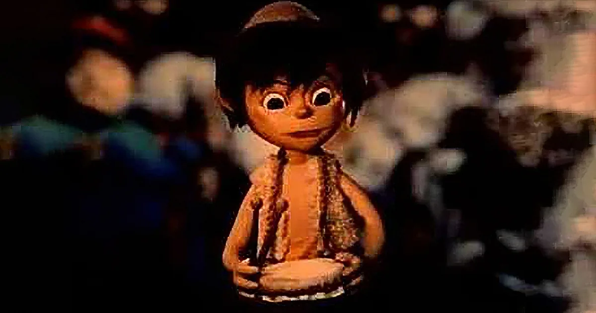 A cartoon character with large eyes and a brown hat stands in a dimly lit environment.