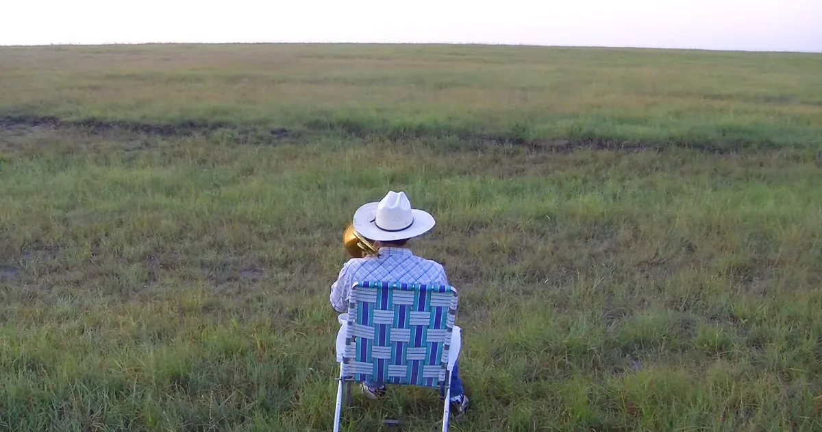 A Farmer Takes a Seat in an Empty Field and Starts Playing Trombone, but Look Who Comes Running to Enjoy His Music