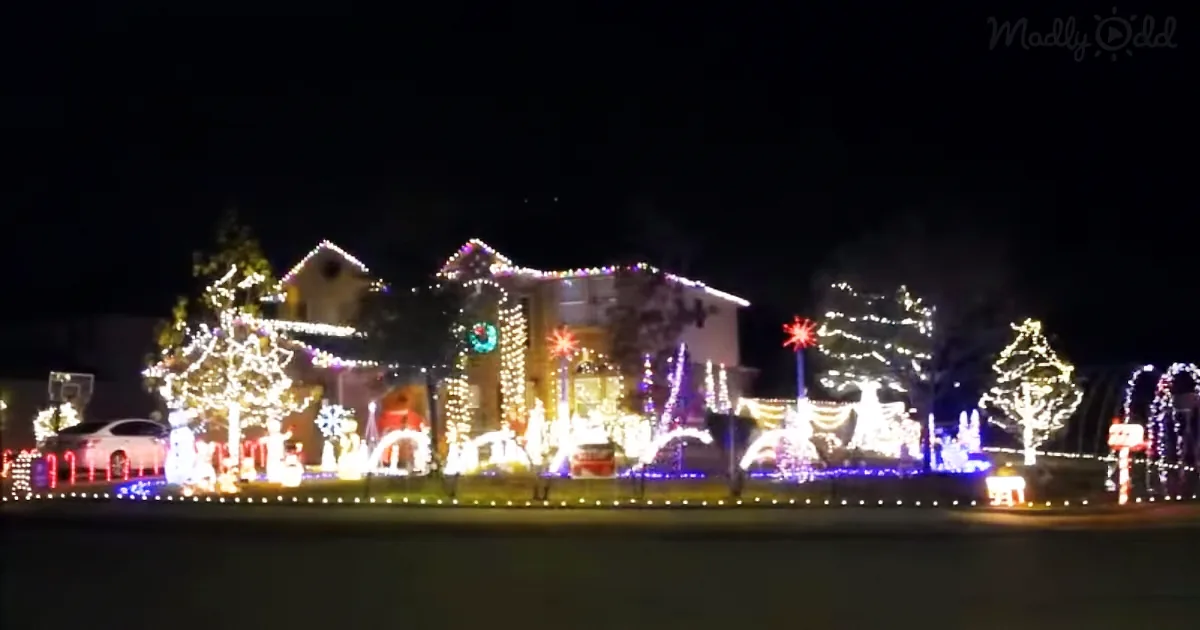 A house adorned with festive Christmas lights and decorations, including trees, reindeer, and a star, creating a magical...