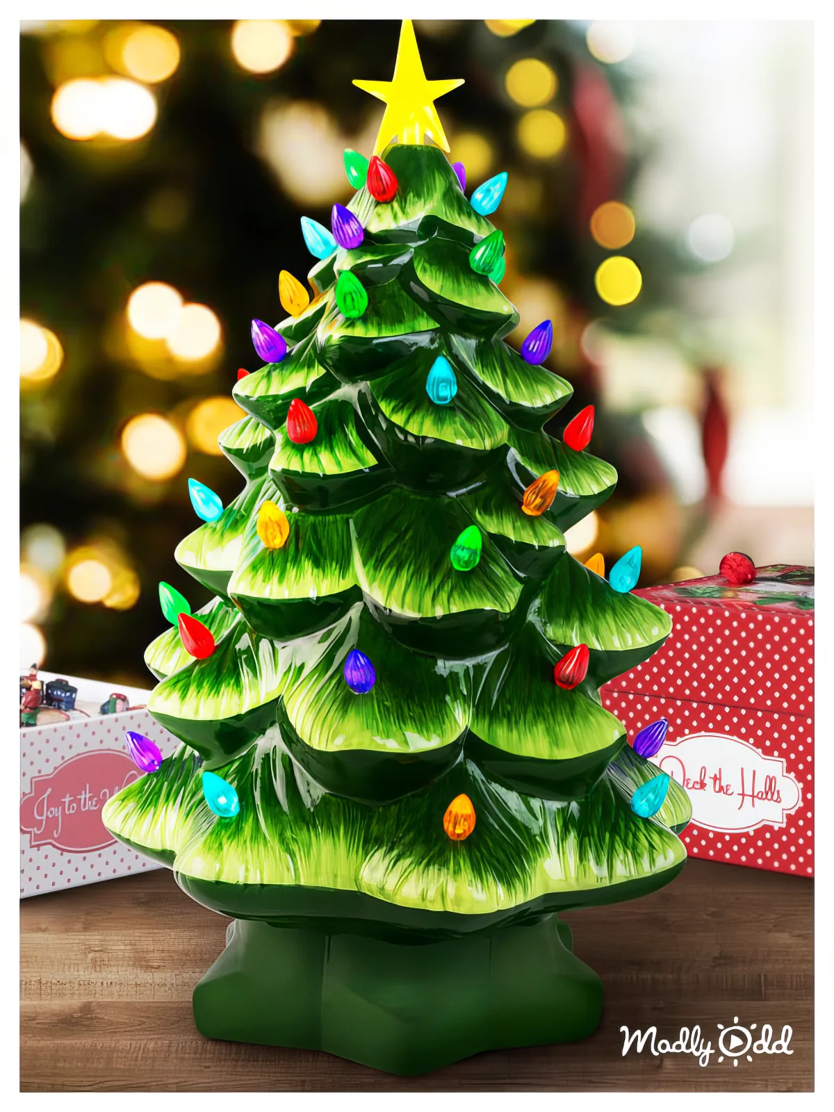 A ceramic Christmas tree with colorful lights and a star on top, set against a festive background.