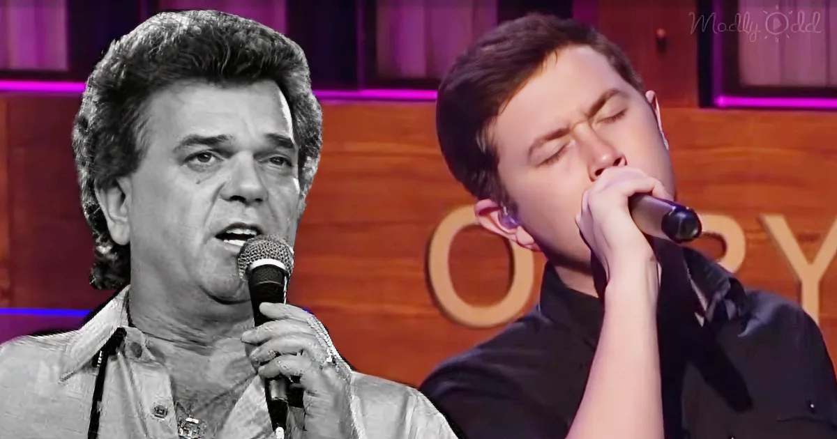 Two men singing into microphones, one in black and white, the other in color, on a stage.
