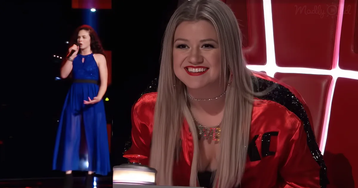 A woman in a blue dress sings on stage, while another woman in a red outfit smiles and presses a button.
