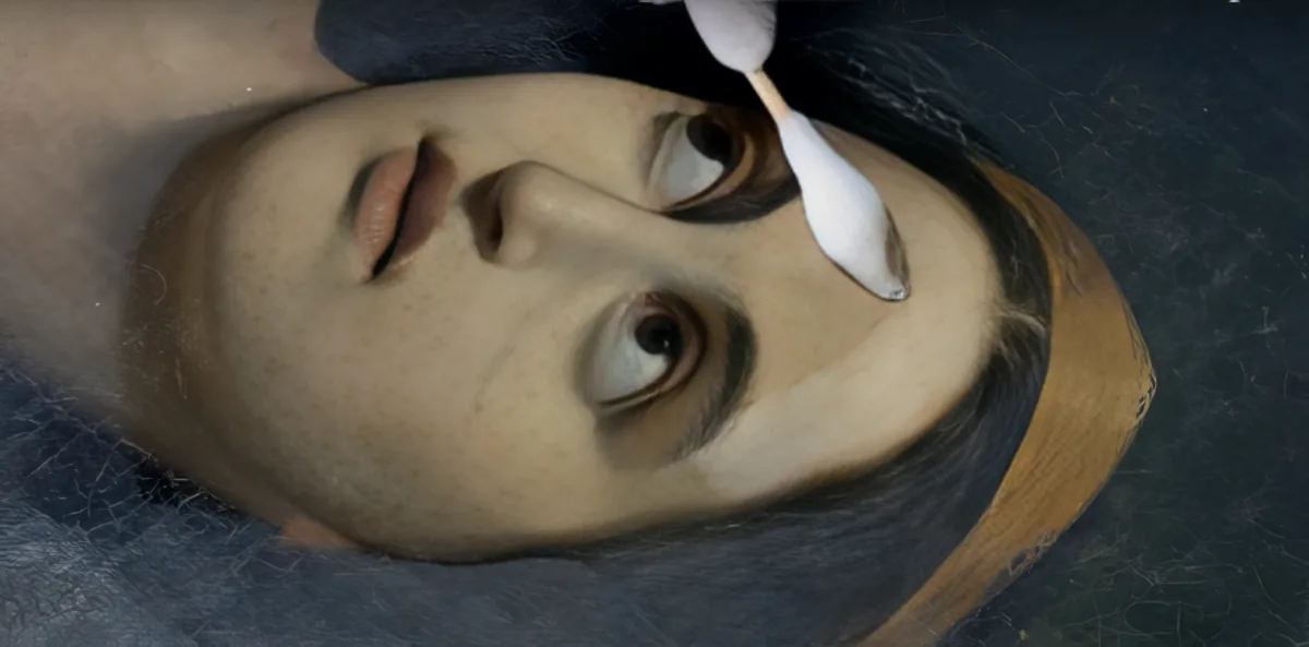 A person's face is being cleaned with a cotton swab, revealing a textured surface underneath.
