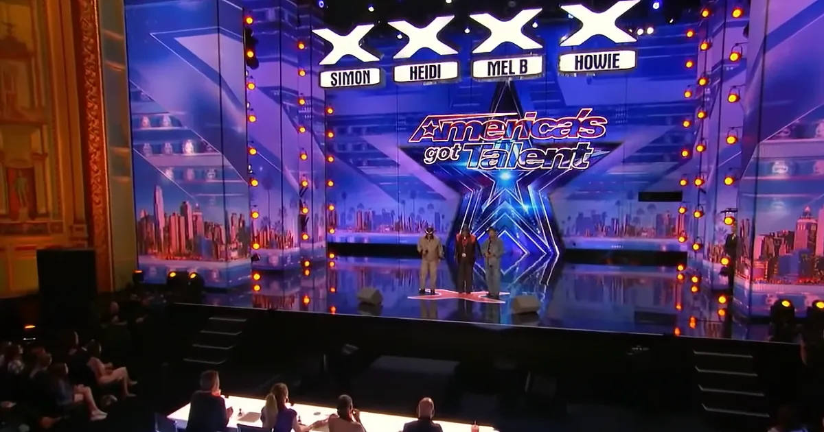 Judges Simon, Heidi, Mel B, and Howie on stage at America's Got Talent.