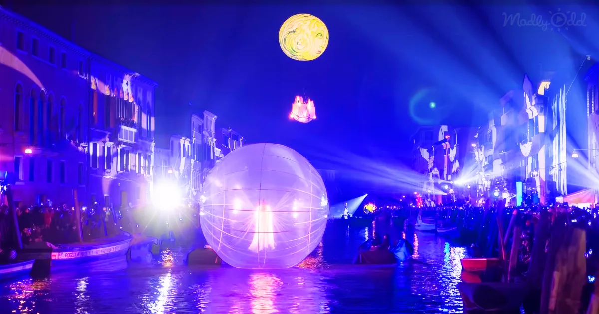 A large glowing orb floats above a canal, surrounded by colorful lights and buildings, creating a surreal nighttime scene.