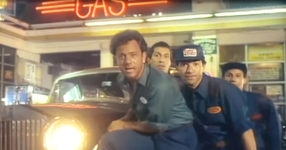A man in a green shirt is being chased by security guards in a gas station.