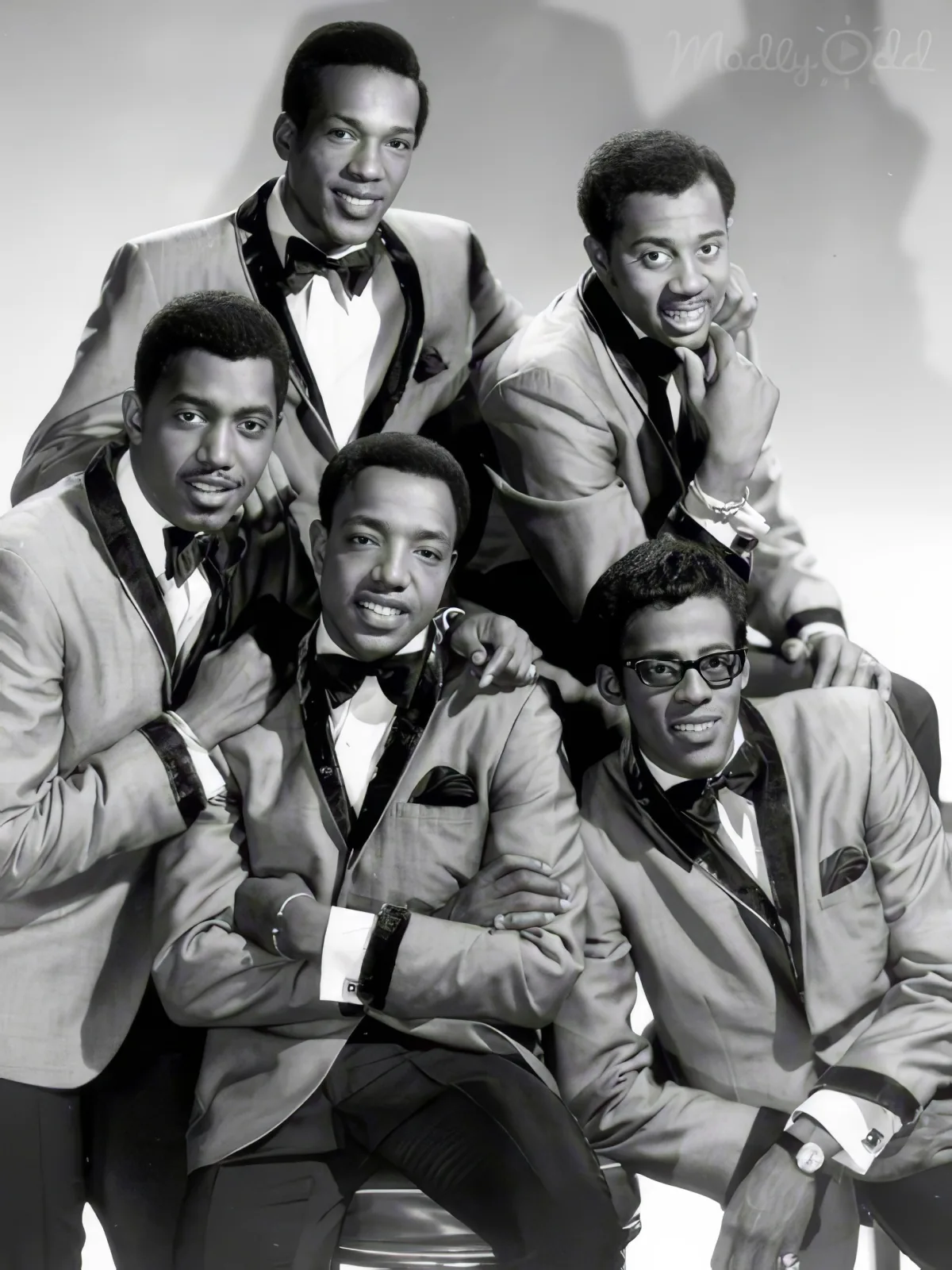 A group of six men in suits, posing together in a vintage style, likely from the mid-20th century.