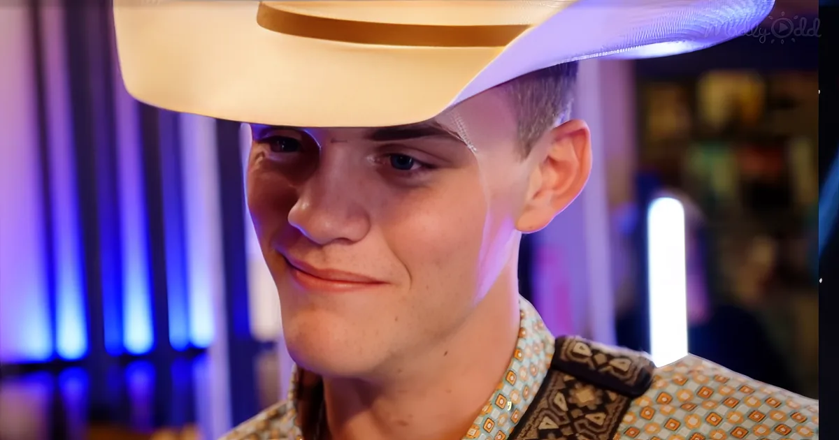 A person wearing a white hat and patterned shirt smiles in a dimly lit room with blue lighting.