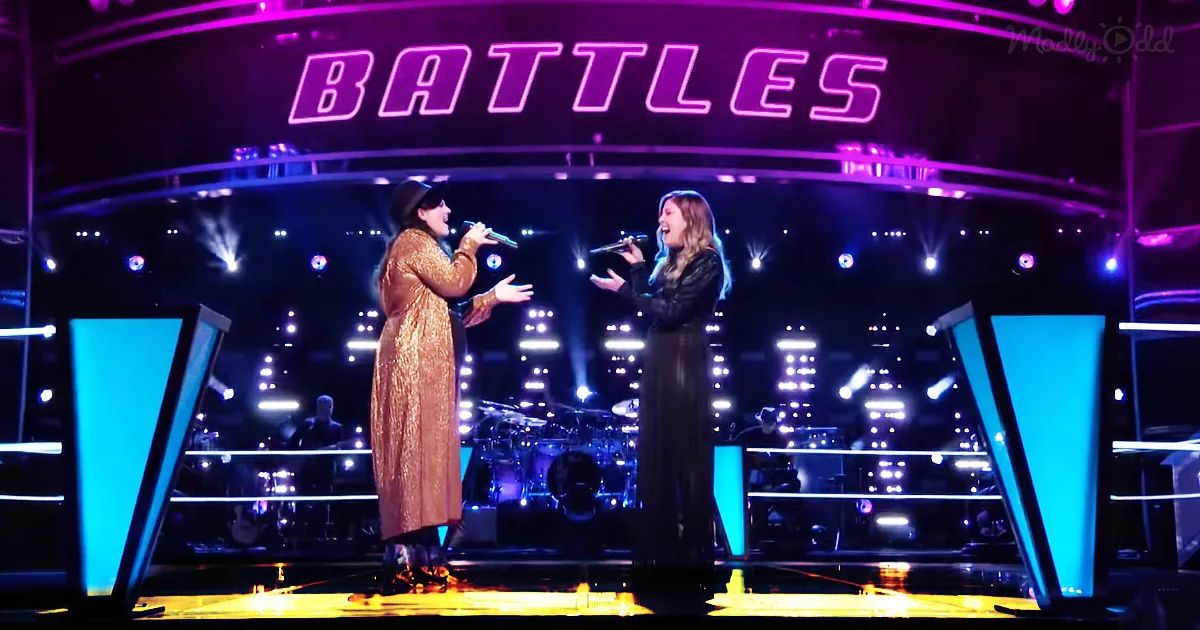Two women sing on stage under "BATTLES" sign with vibrant purple and blue lighting.