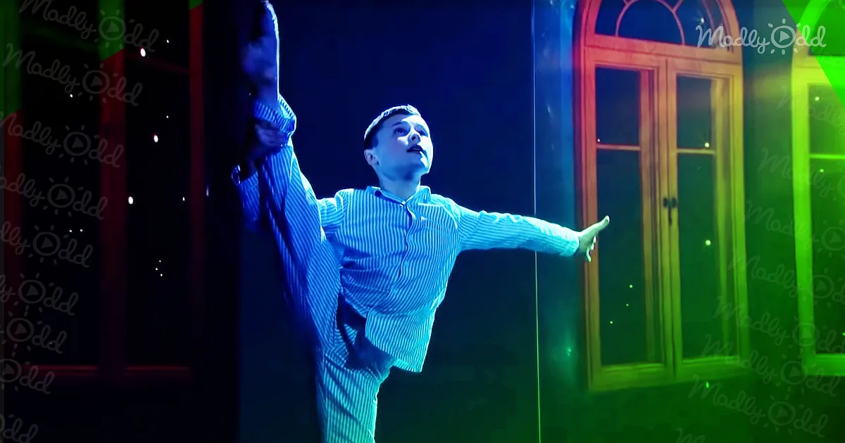A boy in a striped shirt is dramatically reaching upwards with a determined expression.