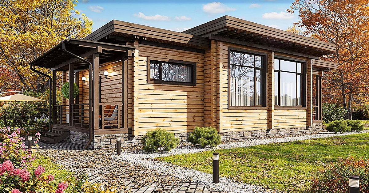 A cozy wooden cabin with a stone foundation, surrounded by autumn foliage and a well-maintained garden.