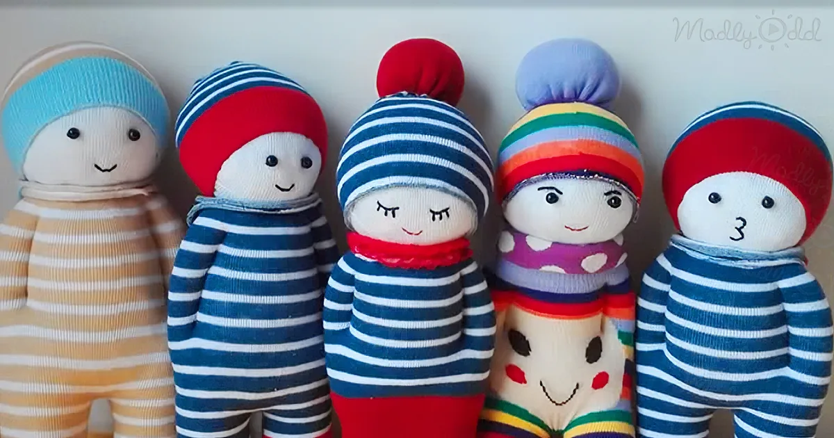 Five colorful sock dolls with various hats and striped outfits stand in a row.
