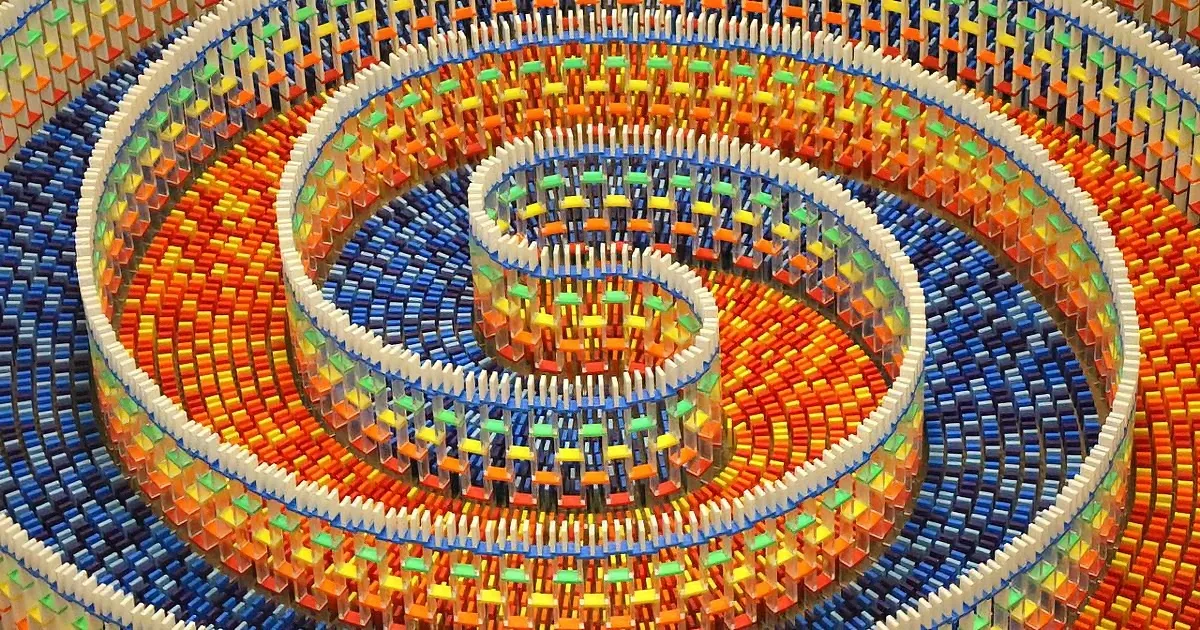 A colorful, intricate spiral structure made of small, rectangular blocks arranged in concentric circles.