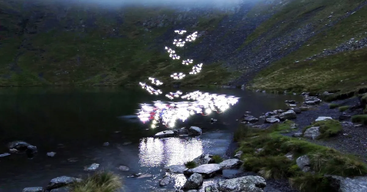 A serene mountain lake with sparkling reflections of sunlight on the water's surface.