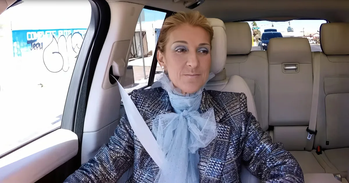 A woman with blonde hair, wearing a patterned jacket and blue scarf, sits in the back seat of a car, looking to the side.