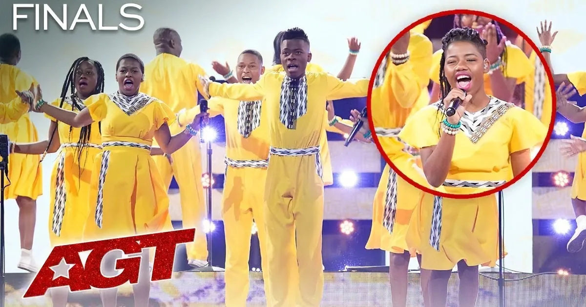 A group in yellow costumes performs on stage, with one singer highlighted in a red circle.