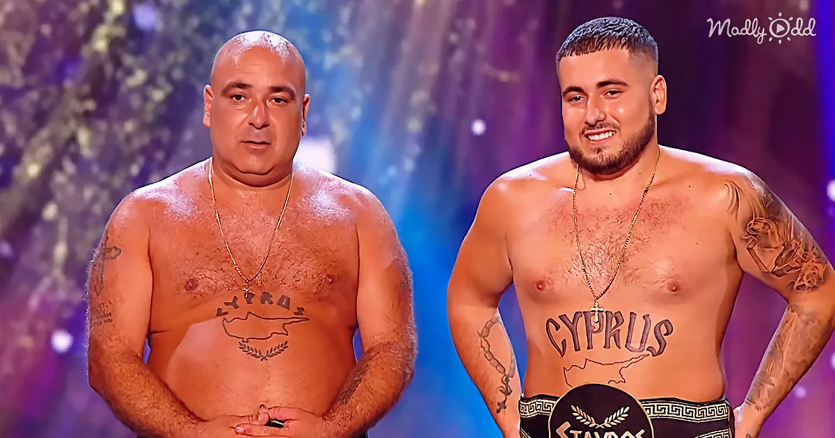 Two shirtless men with Cyprus tattoos stand side by side, one smiling, both wearing necklaces.