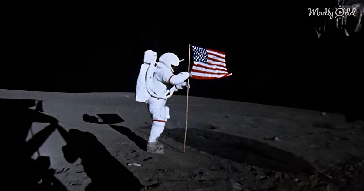 An astronaut in a white suit stands on the moon, planting an American flag.