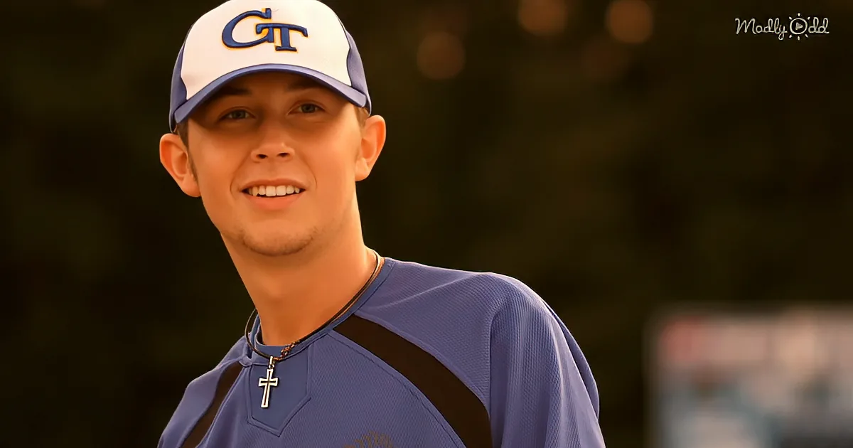 A smiling young man wearing a blue baseball cap with "GT" and a blue jersey with a cross necklace.