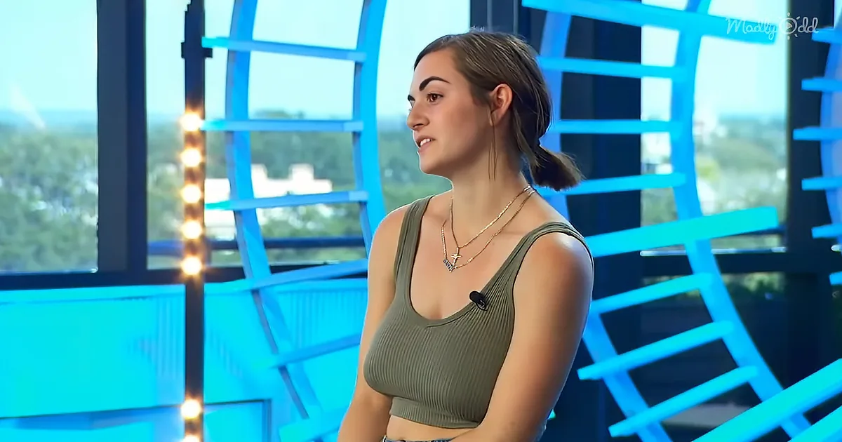 A woman in a green crop top and necklace stands in front of a blue geometric background with lights.