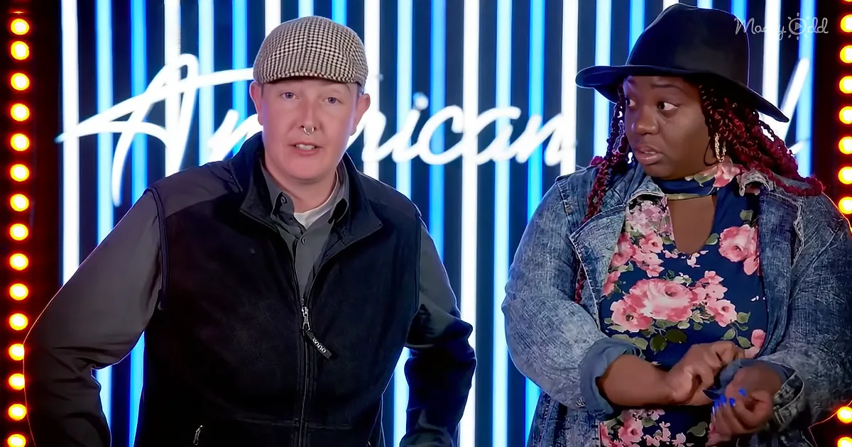 A man in a checkered cap and a woman in a floral shirt stand in front of a "American" backdrop with blue and yellow lights.