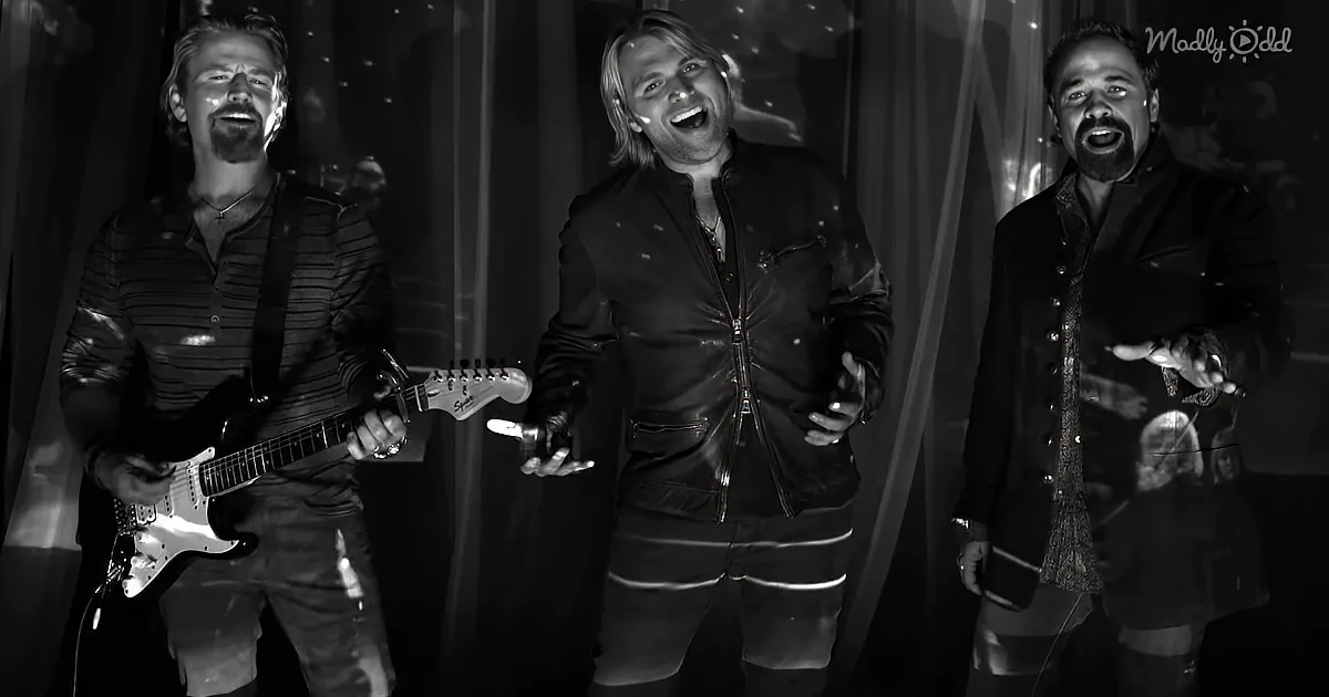 Three men, one playing guitar, all singing, black and white, Madly Odd logo.