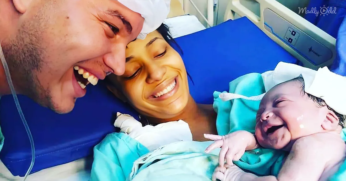 A joyful family moment in a hospital setting, with a smiling father, mother, and newborn baby.