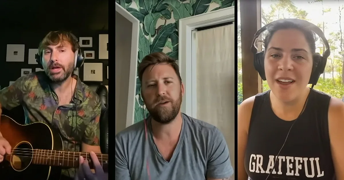 A man in a floral shirt plays guitar while two others, one with headphones, sing in a video call.