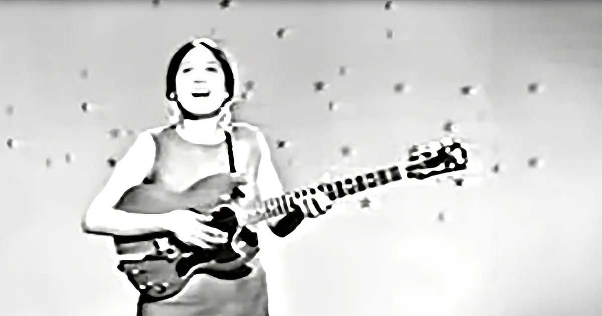 A person in a white shirt plays a guitar with a starry background.