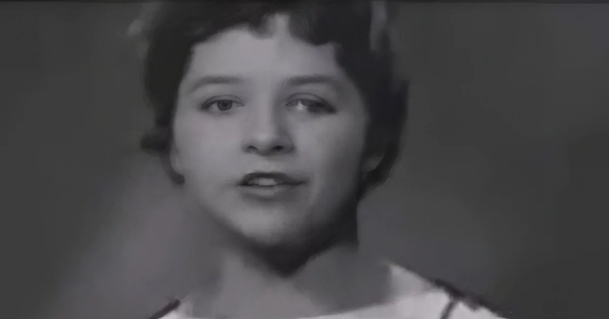 A young child with short hair, wearing a light-colored top, is shown in a black-and-white image.