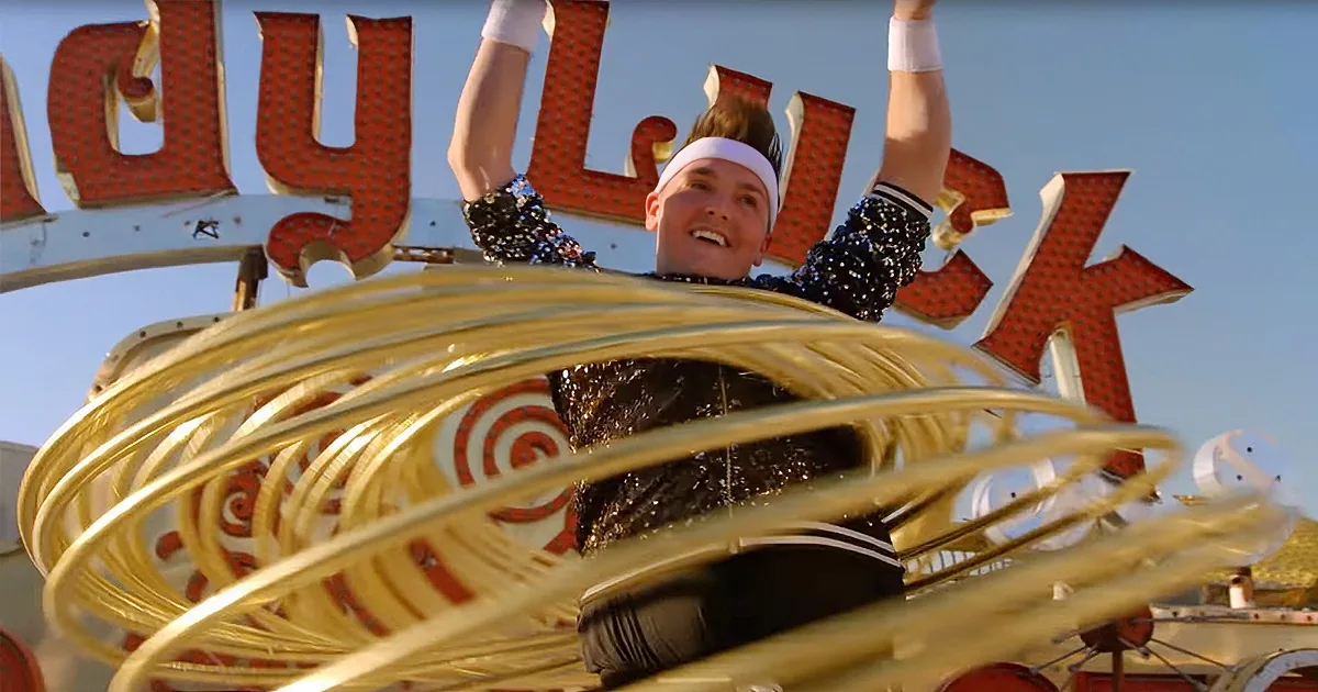 A person in a festive outfit is surrounded by golden rings, with a "Lucky" sign in the background.