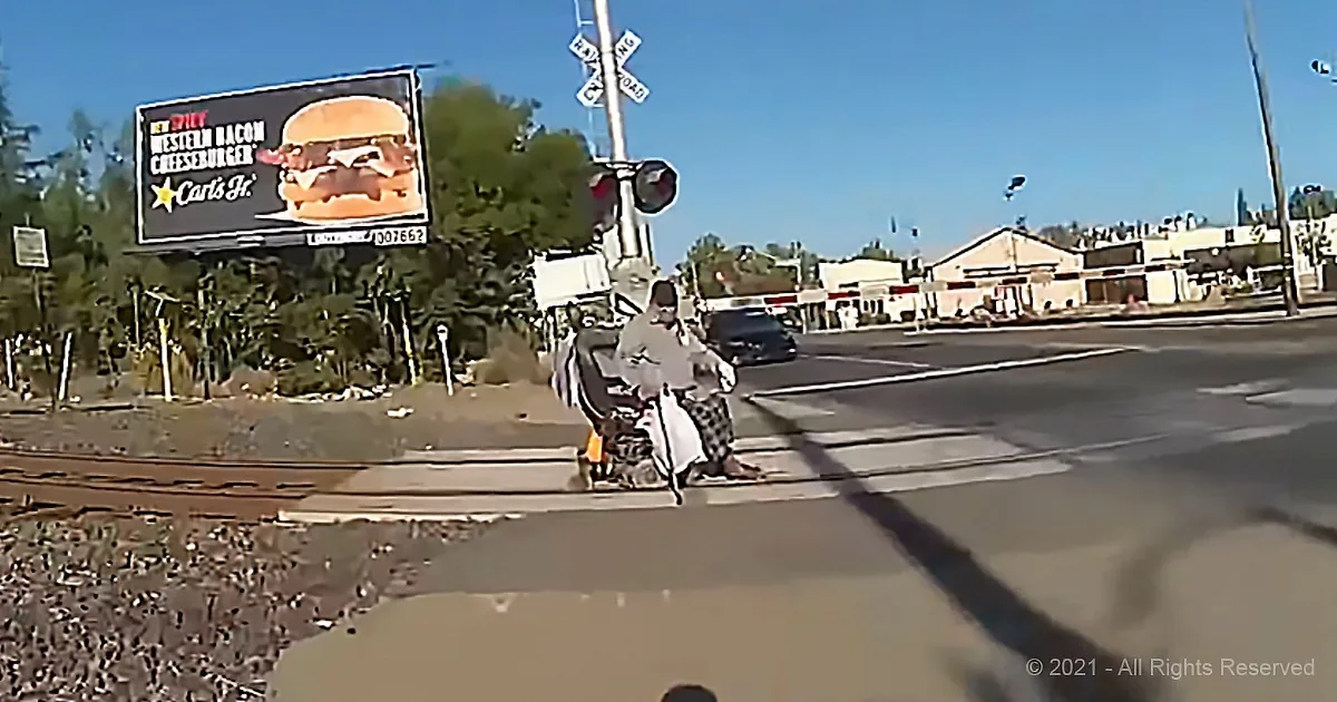Man in Wheelchair Stuck on Railroad Tracks Gets Heroically Rescued Just in Time