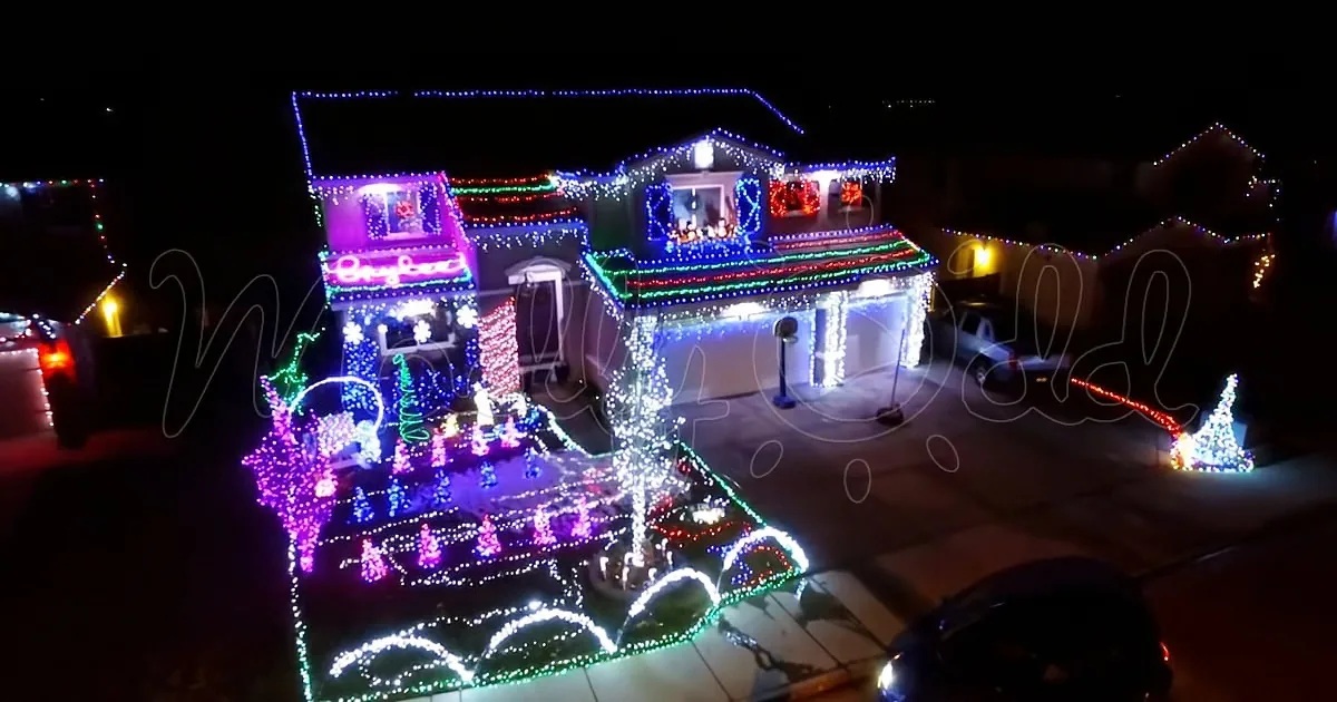 A house is adorned with vibrant Christmas lights, creating a festive display.