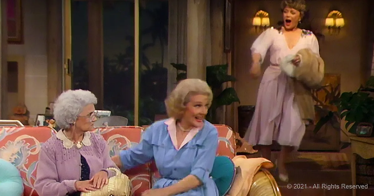 A woman in a white dress dances excitedly while two seated women watch, one holding a basket.