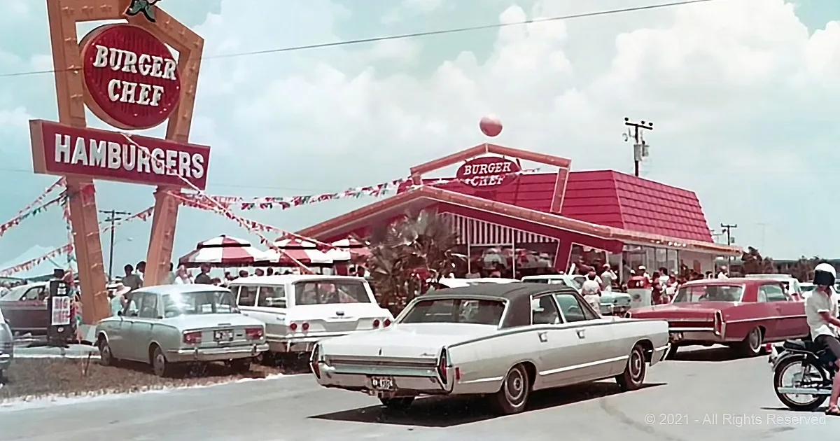 Burger Chef restaurant with vintage cars and people in a parking lot.