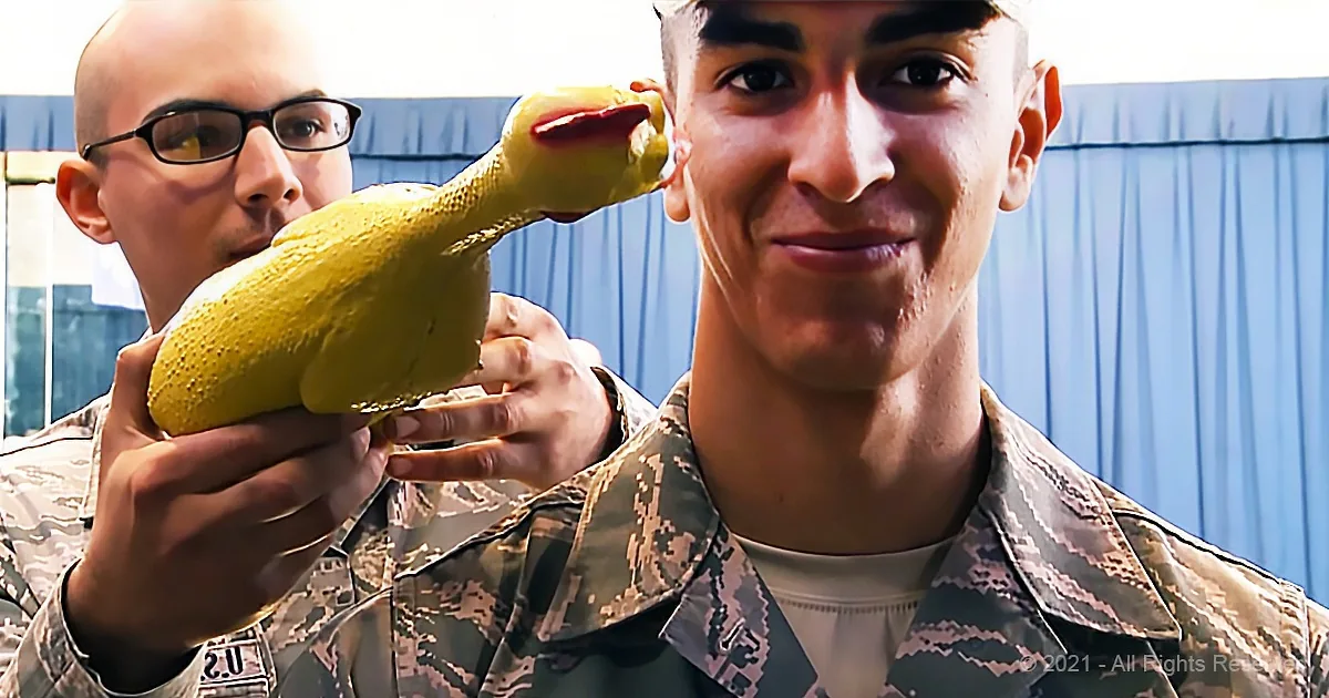 A person in military uniform holds a large, yellow, textured object resembling a chicken leg.