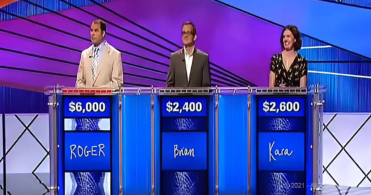 Three contestants, Roger, Brian, and Kara, stand at podiums with their scores displayed.