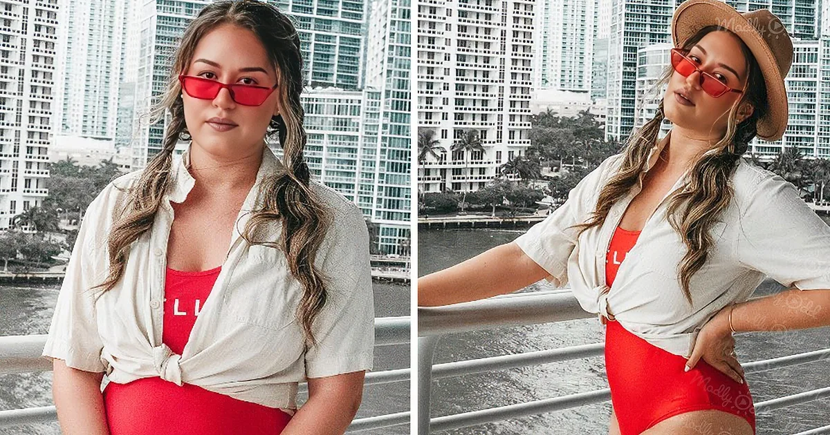 A woman in red sunglasses and a white shirt poses confidently against a cityscape backdrop.