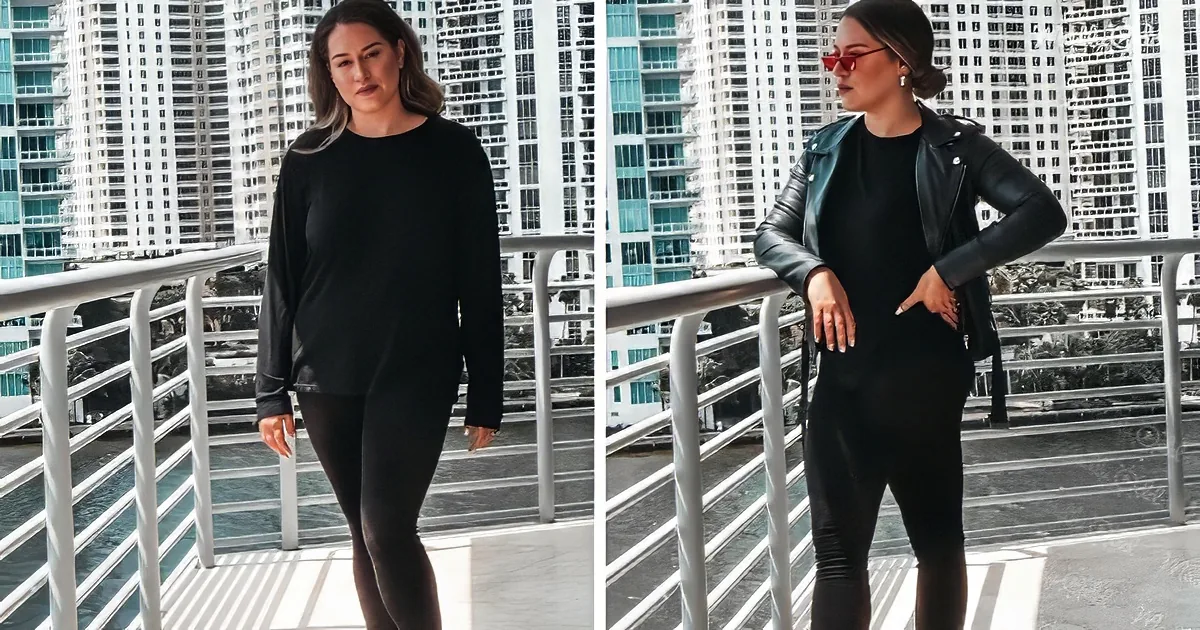 A woman stands on a balcony, wearing a black top and leggings, with a cityscape of tall buildings in the background.