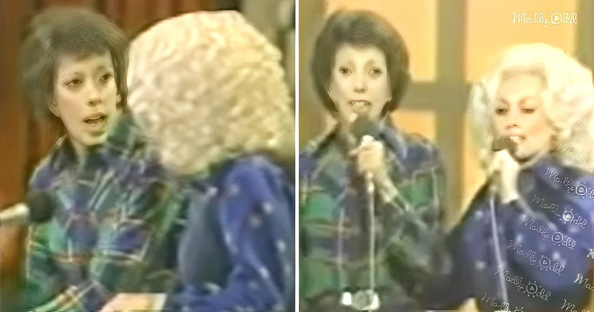Two women, one with curly hair, are singing into microphones, wearing patterned outfits.