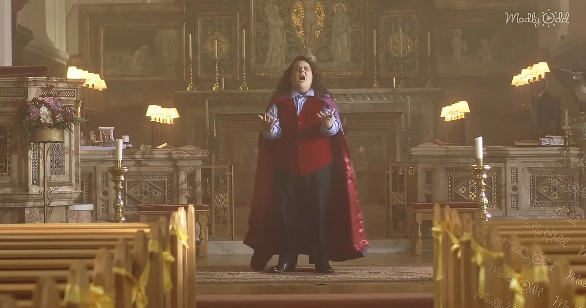 A person in a red cape stands in a church, arms outstretched, mouth open.