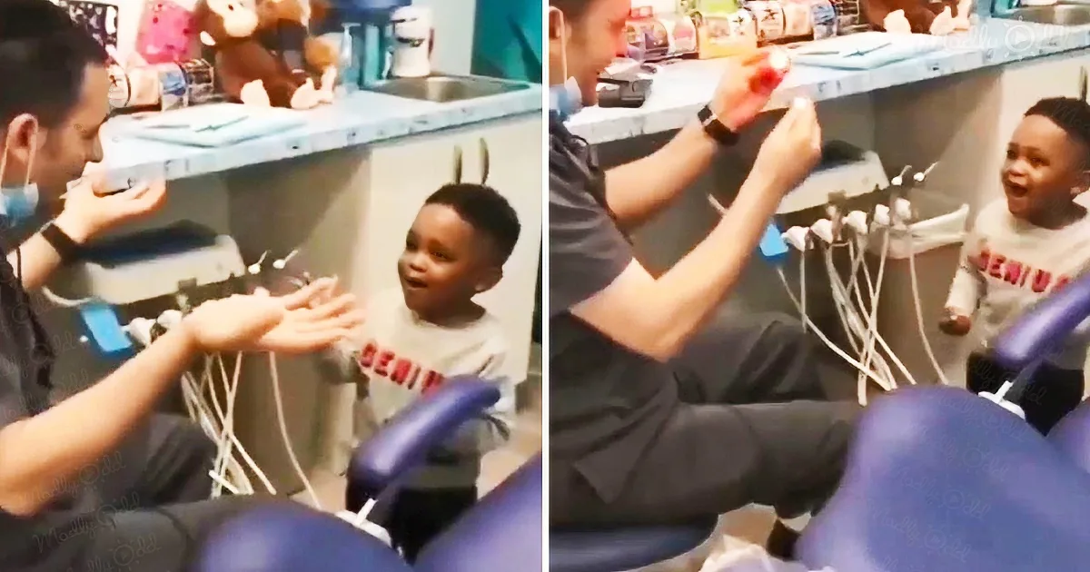 A dentist interacts with a young child in a dental office, creating a positive experience.
