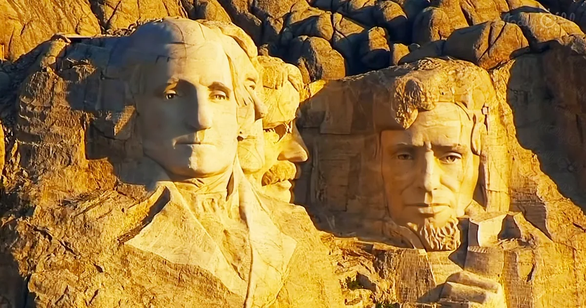 Mount Rushmore features carved faces of U.S. presidents George Washington and Abraham Lincoln.
