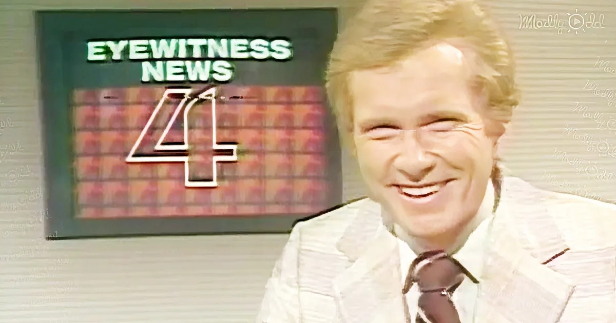 A smiling man in a suit and tie stands in front of a "Eyewitness News 4" sign.