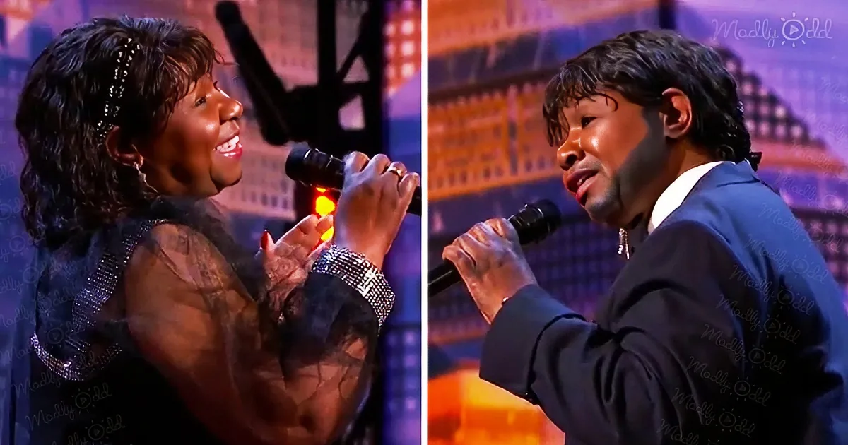 A woman in a black dress sings passionately, holding a microphone, while a man in a suit sings beside her.