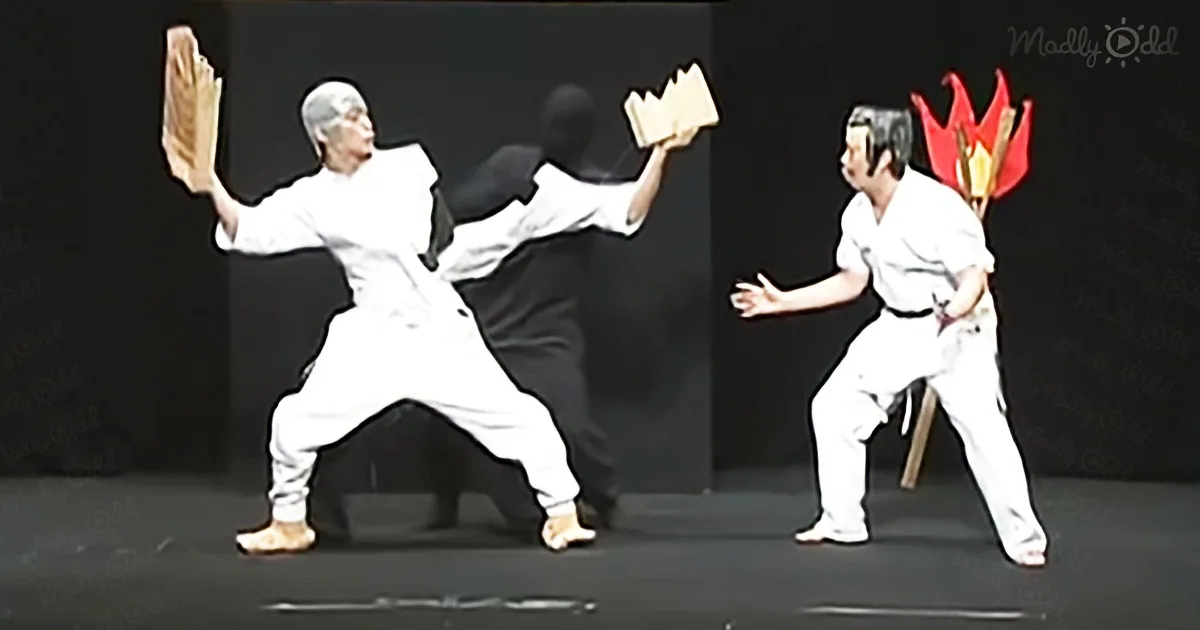 An older man in white martial arts attire performs a high kick, while another person in a white uniform with a red...