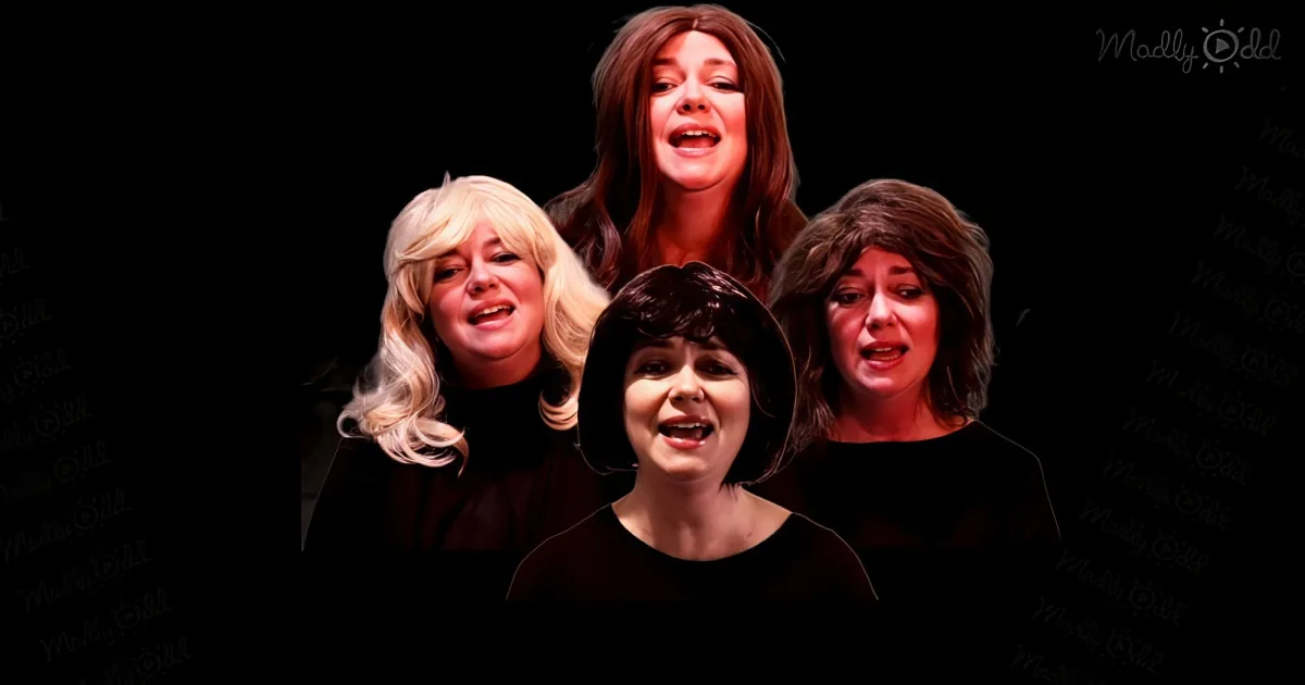 Four women in black attire, singing with expressive faces, against a dark background.