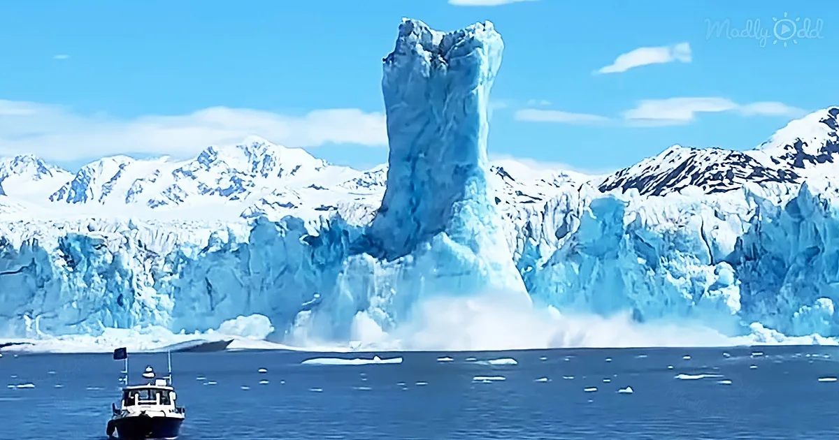 A towering iceberg crashes into the water, creating a dramatic splash, with a boat nearby and snow-capped mountains in...