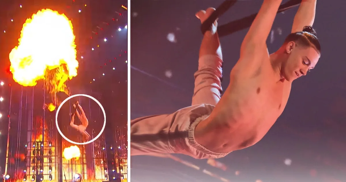A shirtless acrobat performs a daring aerial trick amidst a fiery backdrop.