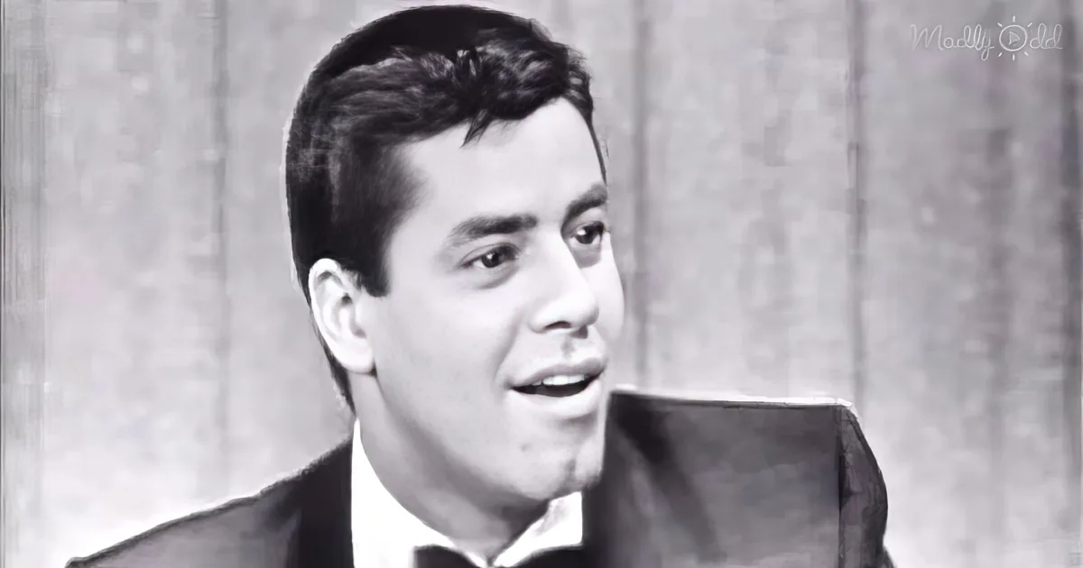 A man in a suit and tie is shown in a black-and-white image, looking to the side.